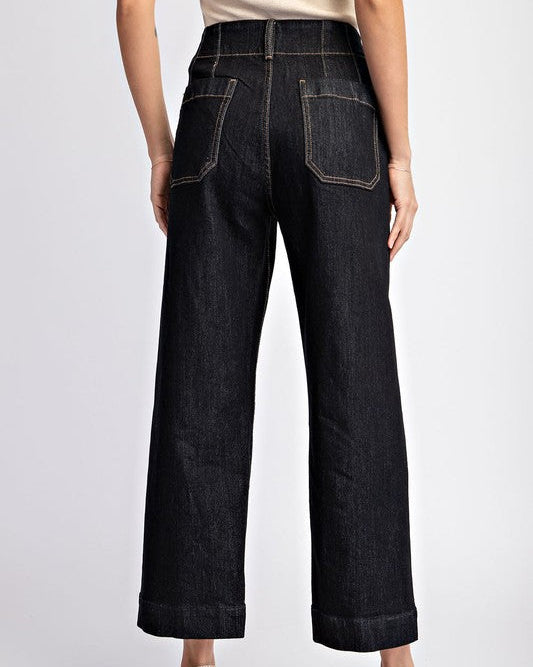 Person wearing dark blue jeans on a white background